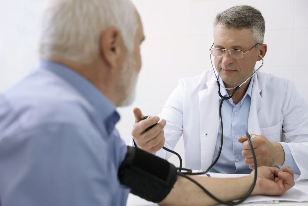 Nurse checking a patient's blood pressure